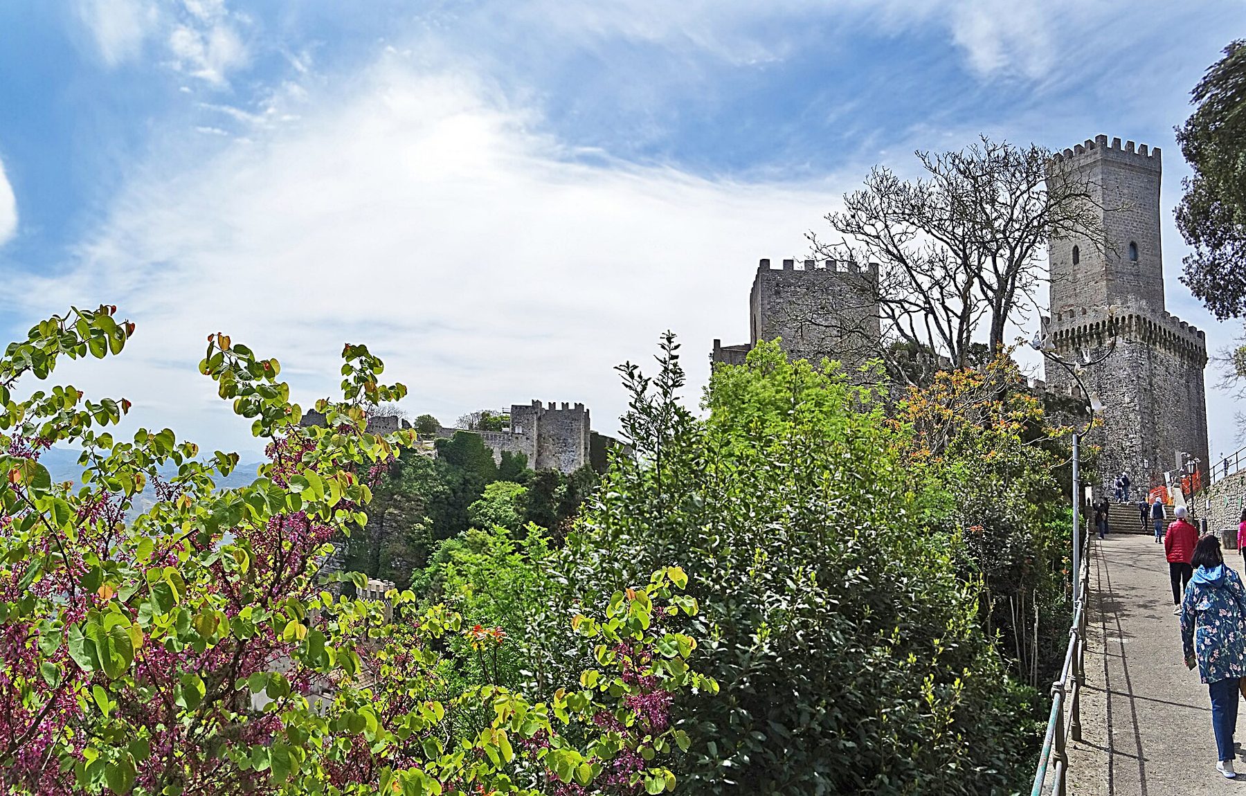 A panoramic view across the rooftops of Erice with the sea in the distance.
