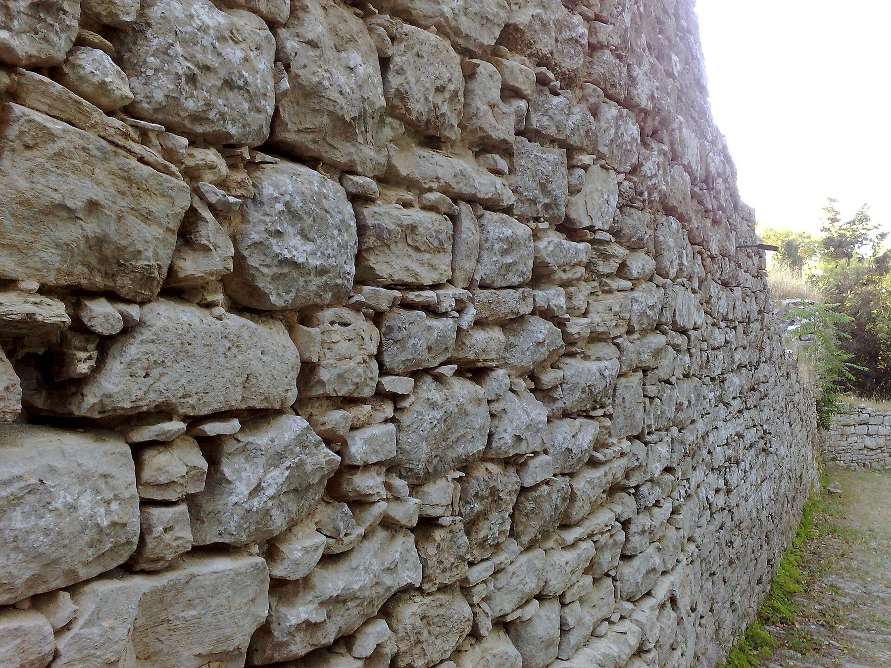 A section of the ancient Elymian-Punic walls of Erice, showing the irregular megalithic blocks at the base.